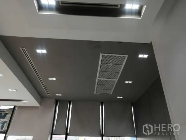 Office Space for rent in Pathum Wan, Bangkok - Office ceiling with recessed lighting, ducted air-conditioning, and tall windows with blinds.