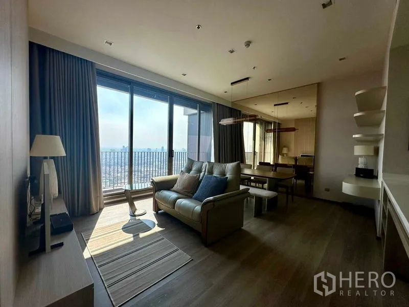 Condominium for rent in Bang Kho Laem, Bangkok - Open-plan living and dining area with large sliding doors to a balcony and sweeping skyline views.