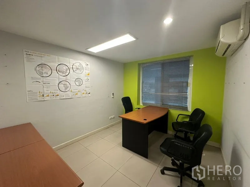 Office Space for sale - Compact private office with desks, task chairs, air conditioning and a lime accent wall.