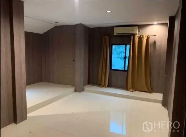 Detached House for rent or sale in Wang Thonglang, Bangkok - Versatile room with wood-panel walls, white tile floor, small window and AC unit.
