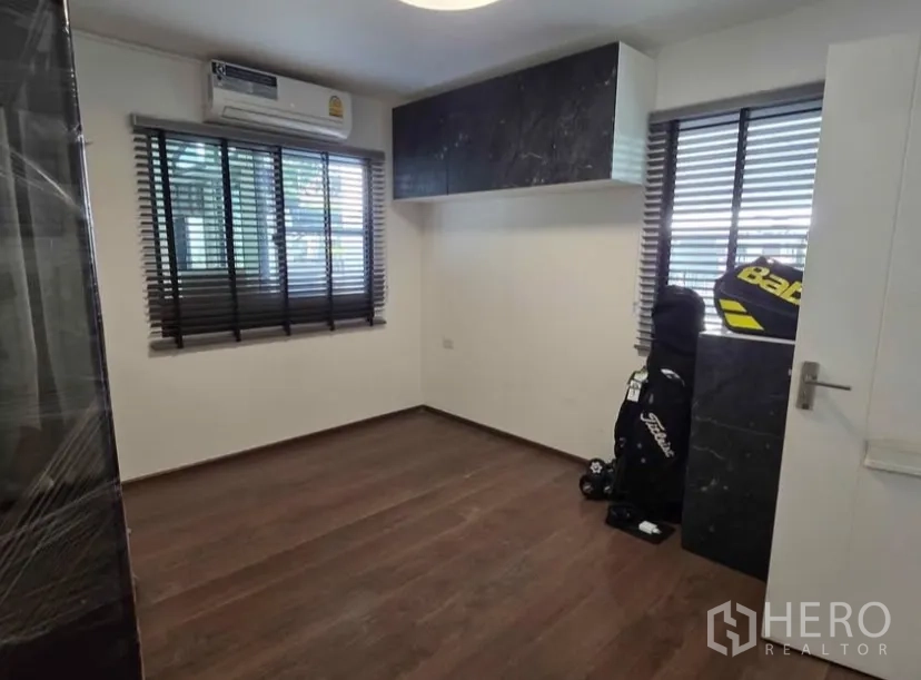 Detached House for rent in Bang Phli, Samut Prakan - Third bedroom or flex room with wood floors and dark blinds