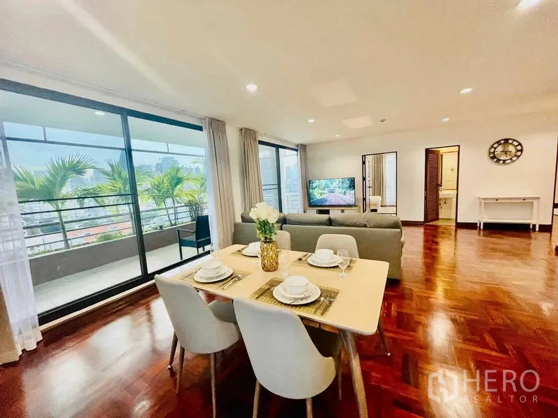 Condominium for rent - Dining area and sofa beside wide sliding doors to the terrace.