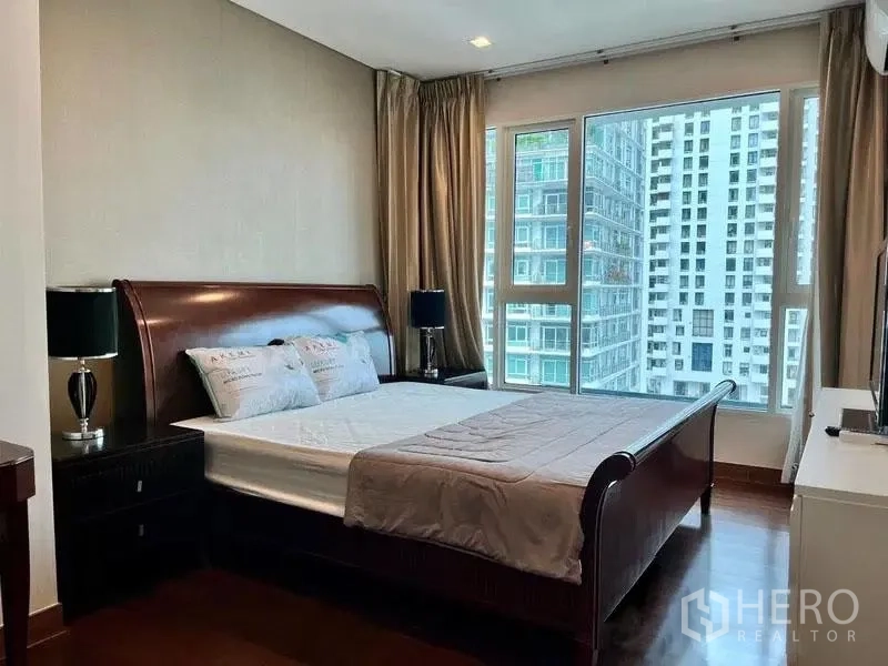 Condominium for rent in Watthana, Bangkok - Master bedroom close-up showing the bed and panoramic windows.