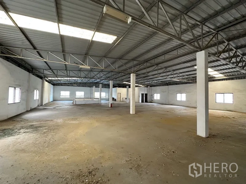 Factory for rent or sale in Bang Bua Thong, Nonthaburi - Large mezzanine or upper-level storage area with steel trusses and side windows.