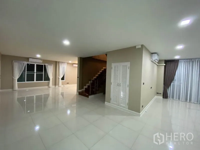 独立式住宅 出租在Prawet, Bangkok - 一层大开间起居区，多扇窗与空调设备，动线宽敞。