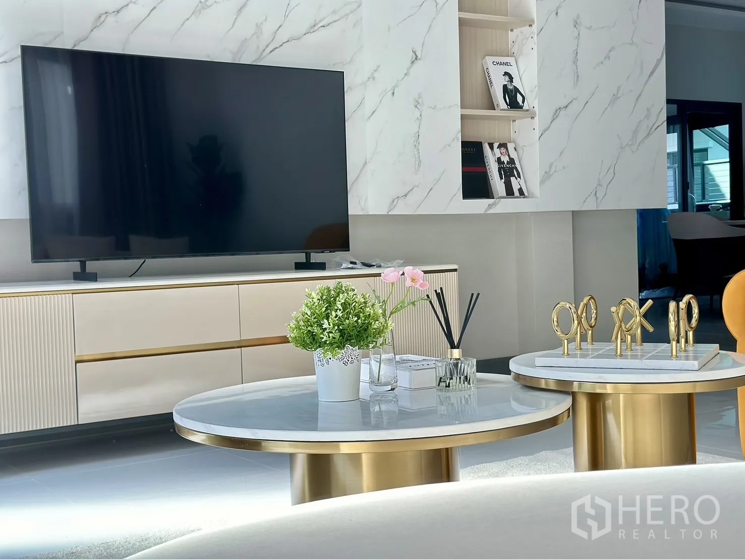 Detached House for rent or sale - Media wall with large flat-screen TV, marble feature, minimalist console and styled coffee tables.