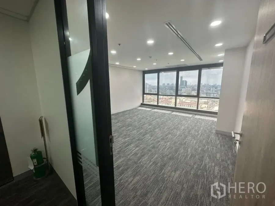 Office Space for rent in Khlong Toei, Bangkok - Private office with panoramic windows, grey carpet and skyline views beyond a sliding glass door.