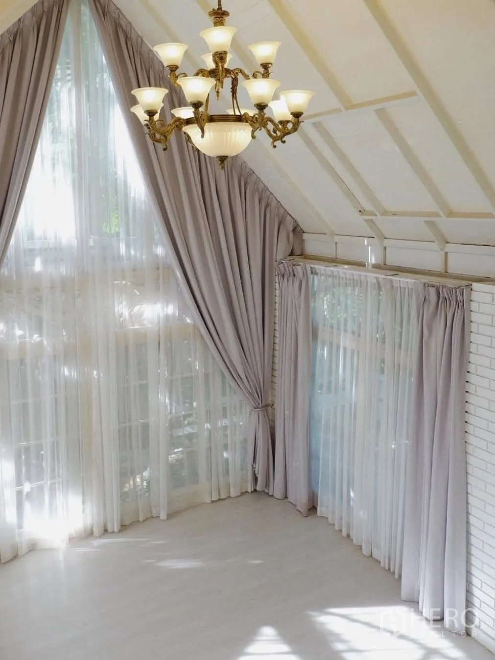 Detached House for rent in Phra Khanong, Bangkok - Open loft-style space with floor-to-ceiling windows and an ornate chandelier.