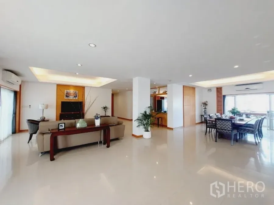 Apartment for rent - Spacious open-plan living and dining space with glossy floors and recessed ceilings.