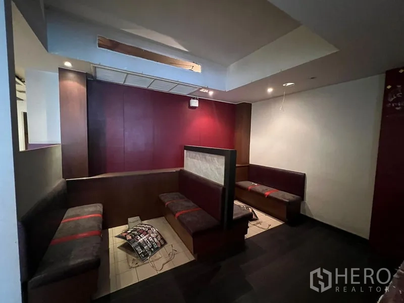 Shophouse for sale in Bang Rak, Bangkok - Built-in booth seating area with upholstered benches and feature wall.