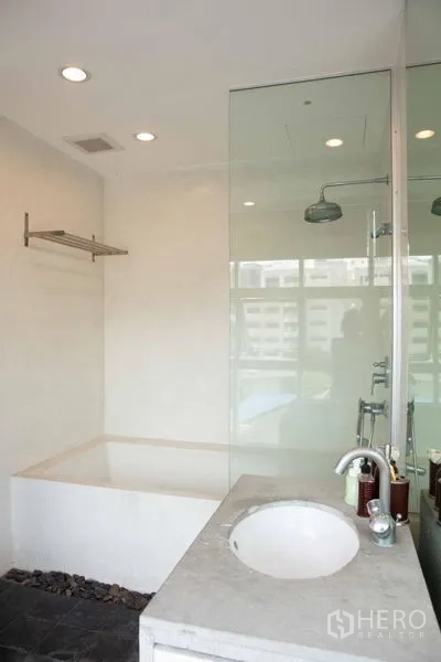 Townhouse for sale - Bright bathroom with glass shower, deep soaking tub and stone vanity.