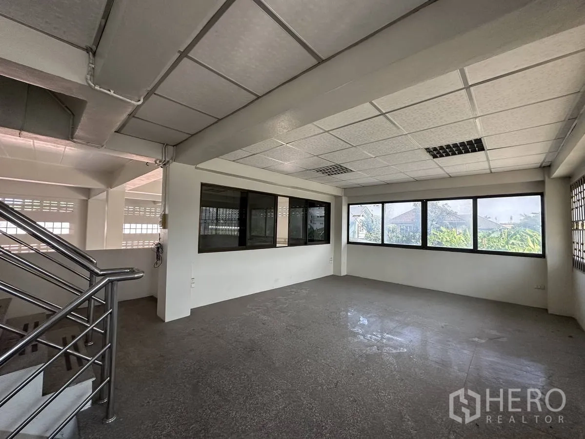 Home Office for rent in Taling Chan, Bangkok - Second-floor office zone with large windows, suspended ceiling and stainless-steel staircase.