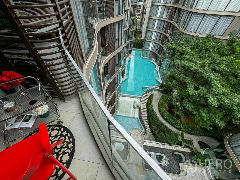 Condominium for rent - Balcony vantage looking down to the lagoon‑style pool and landscaped courtyard.