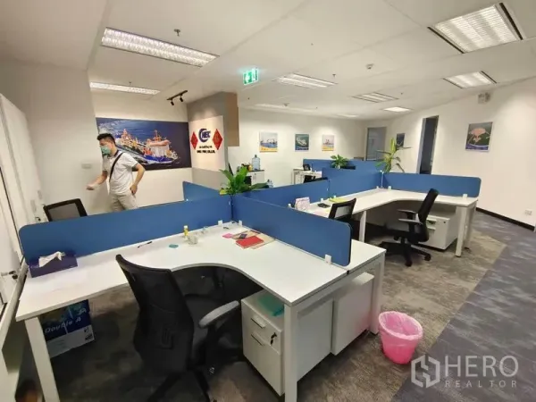 Office Space for rent in Pathum Wan, Bangkok - Modern open-plan office with curved workstations, indoor plants and glass entry.