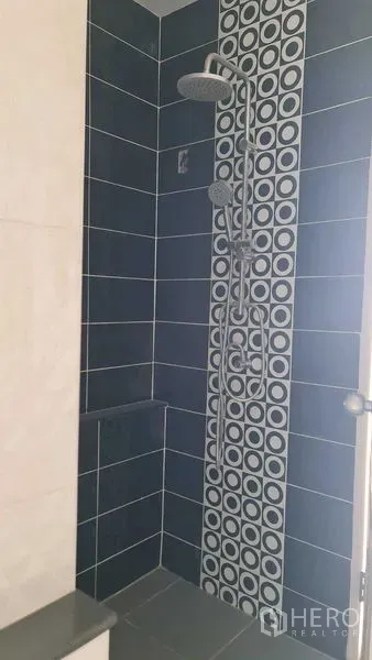 Townhouse for  in Lam Luk Ka, Pathum Thani - Bathroom shower with blue wall tiles and patterned accent strip plus rain shower.