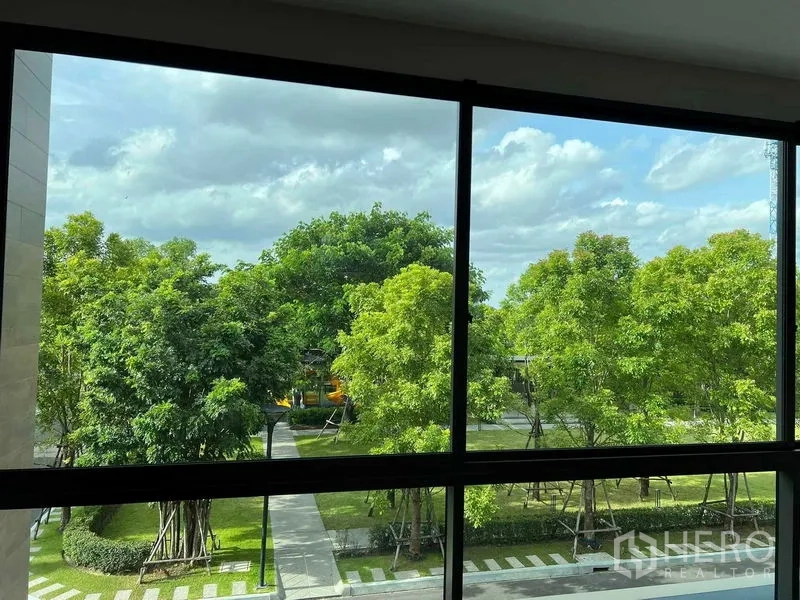 Detached House for sale in Bang Kruai, Nonthaburi - Green park view framed by a large window.