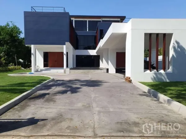Detached House for rent in Phra Khanong, Bangkok - Modern three-storey detached house with a wide driveway and landscaped lawn.