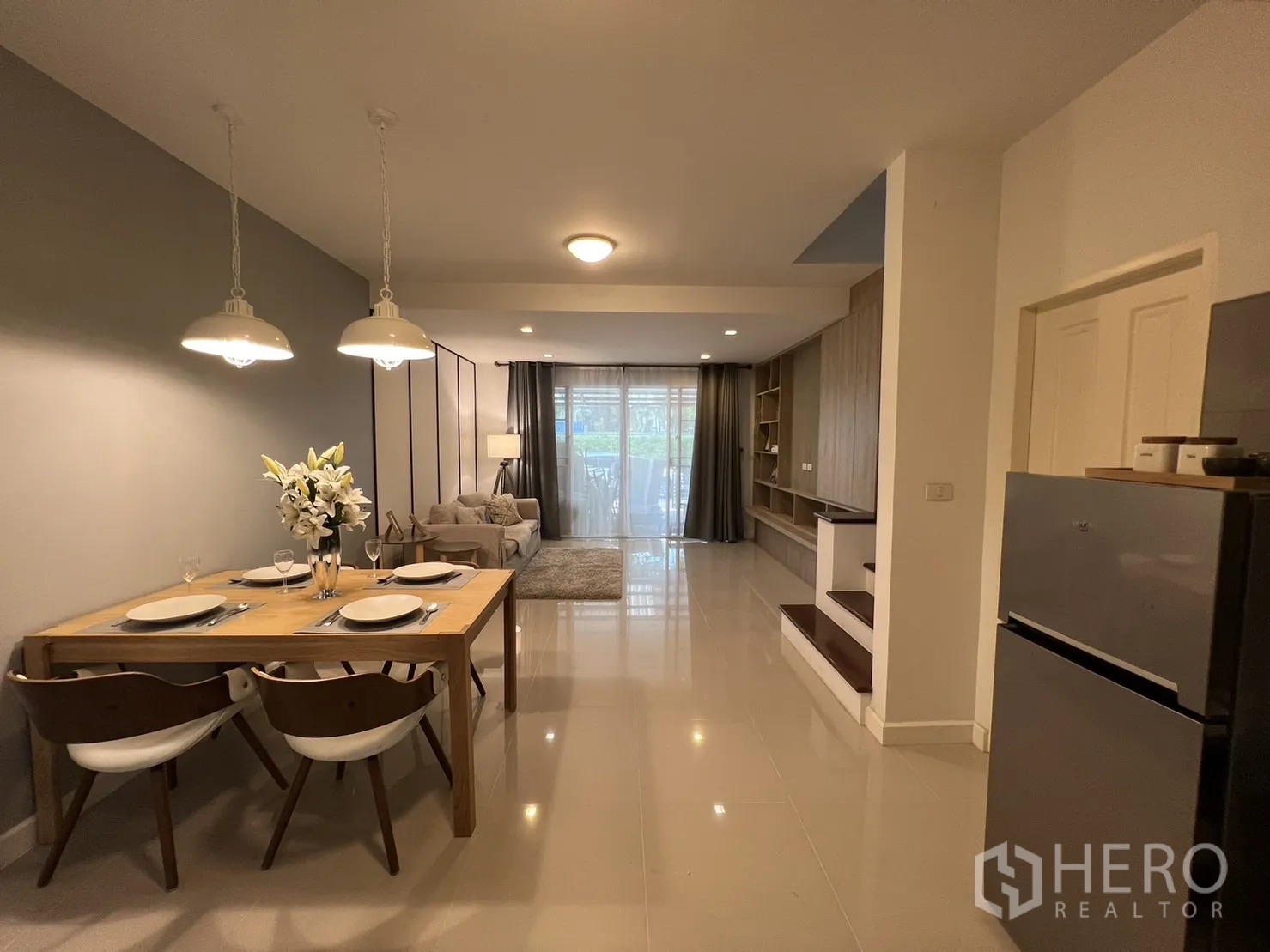 Townhouse for rent in Suan Luang, Bangkok - Dining area with pendant lights facing the living room and kitchen.