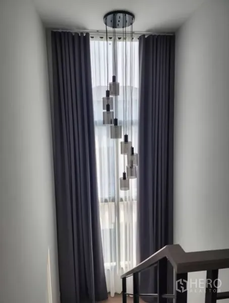 Detached House for rent in Bang Phli, Samut Prakan - Staircase landing with tall window, blackout curtains and pendant lights