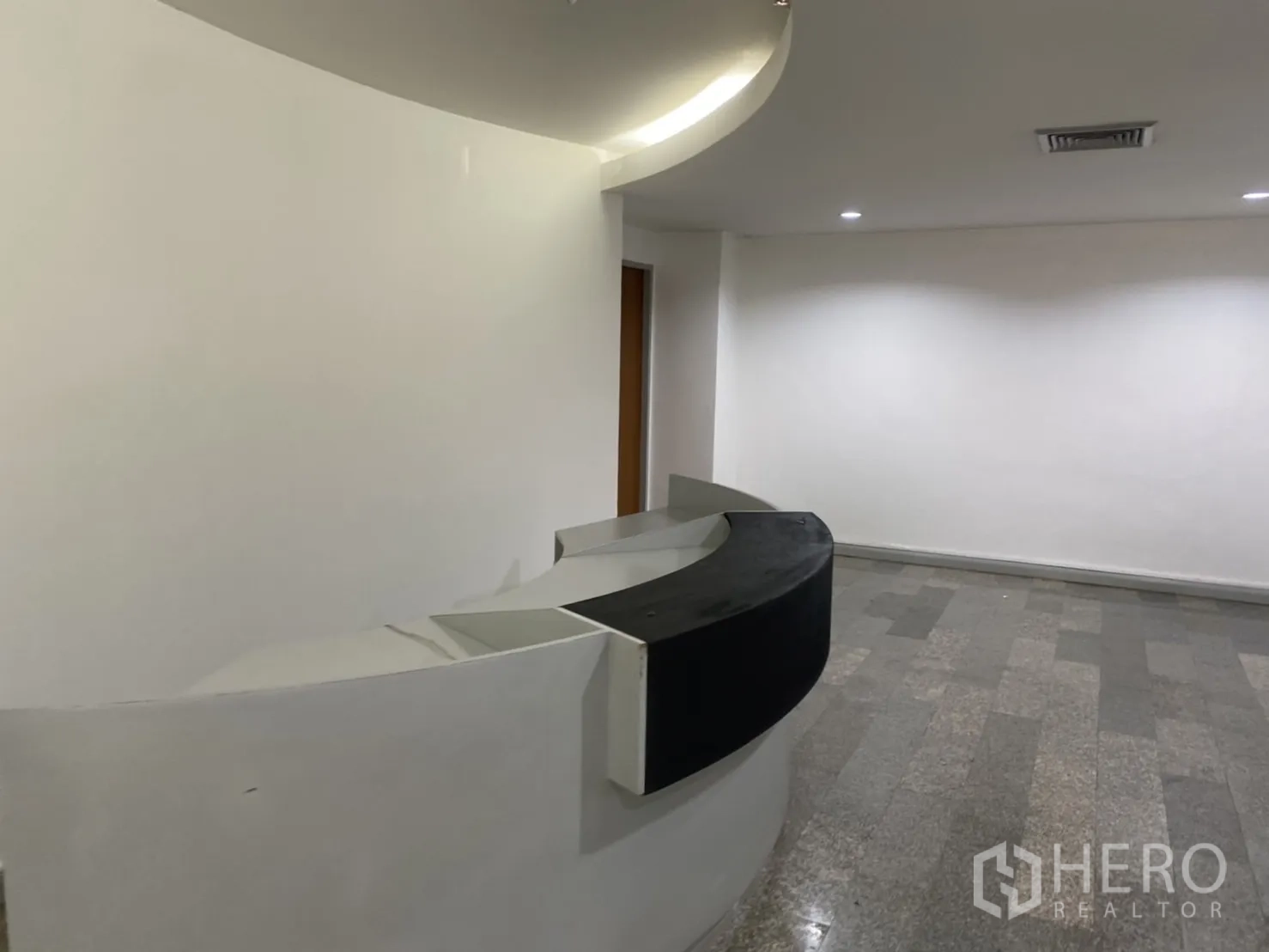 Office Space for rent in Khlong Toei, Bangkok - Reception area from another angle showing the semicircular desk and open workspace beyond.
