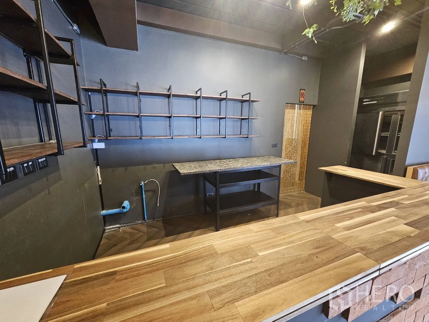 Retail Space for rent in Watthana, Bangkok - Back bar workspace with wooden countertop, open shelving and service sink plumbing.