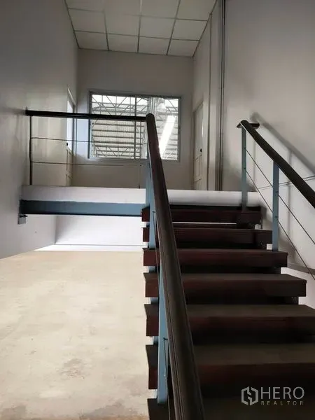 Factory for rent in Phra Nakhon Si Ayutthaya - Internal staircase leading to the mezzanine office overlooking the warehouse floor.