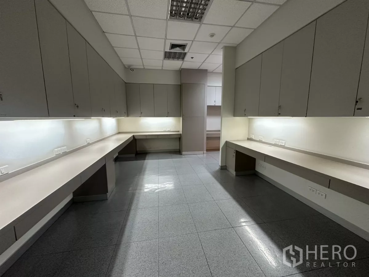 Office Space for rent in Watthana, Bangkok - Opposite view of workroom showing extended counters, power outlets and cabinets.