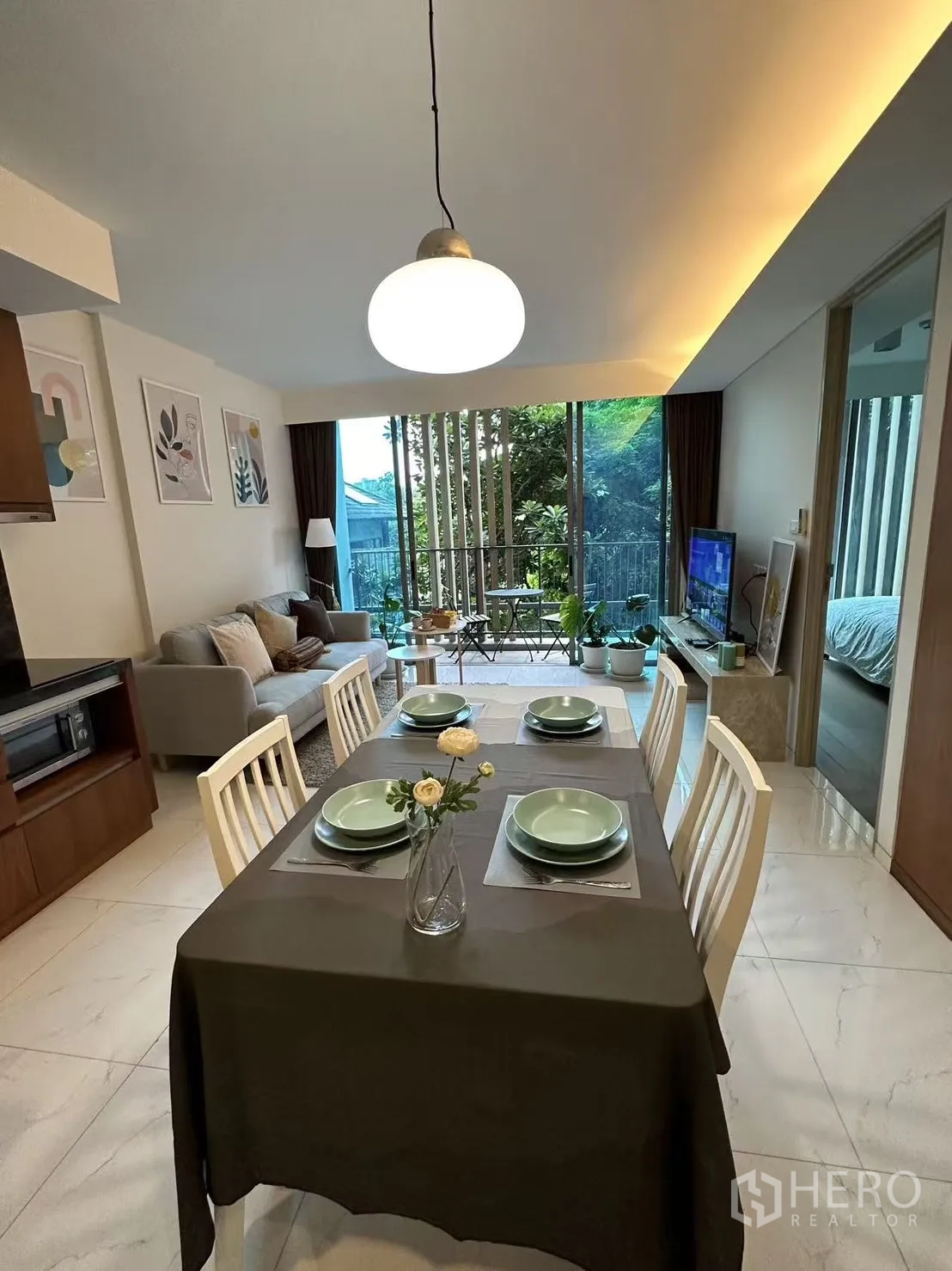 公寓 出售在Watthana, Bangkok - 开放式客餐厅通向阳台，享花园景观。