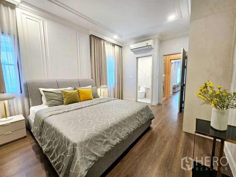 Detached House for rent or sale in Saphan Sung, Bangkok - Bedroom with ensuite bathroom access, layered curtains and soft tones.