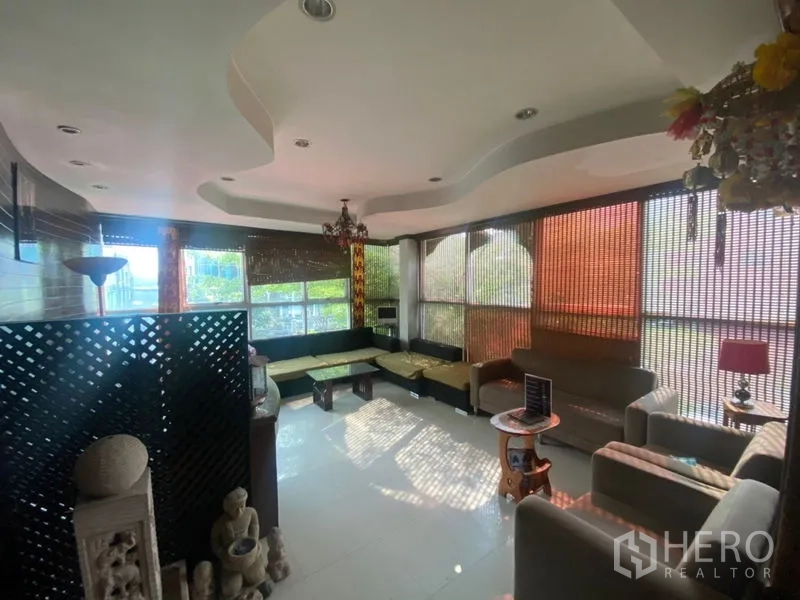 Office Space for rent in Khlong Toei, Bangkok - Corner lounge with large windows, L-shaped seating and decorative ceiling.