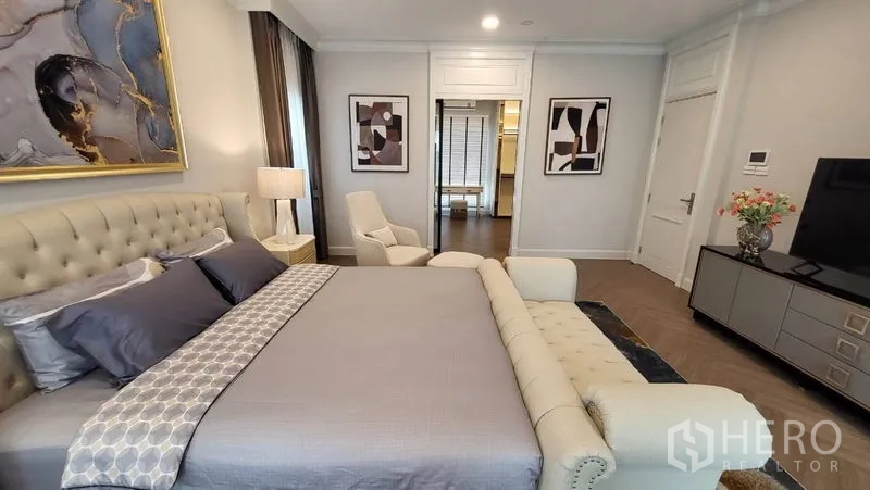Detached House for rent or sale in Saphan Sung, Bangkok - Master suite facing TV wall with artwork and doorway to dressing area.