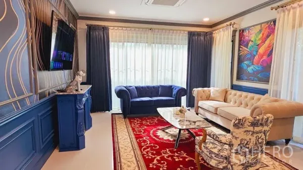 บ้าน ให้เช่าหรือขายในSaphan Sung, Bangkok - มุมนั่งเล่นหรู โซฟาสีน้ำเงินและครีม พรมสีแดง โต๊ะกลางหินอ่อน และหน้าต่างบานใหญ่