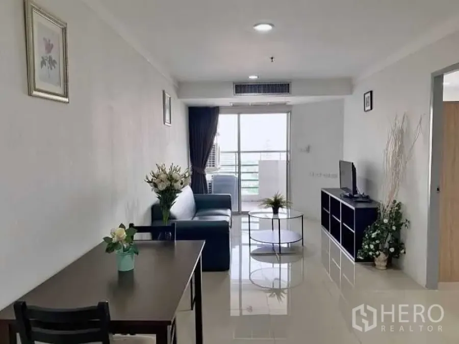 公寓 出租在Khlong Toei, Bangkok - 明亮客厅，配沙发、电视柜、餐桌并连通阳台的素坤逸公寓。