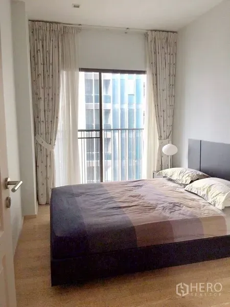 公寓 出租在Bangkok - 卧室配大床，落地窗与推拉门，可通向窄阳台。