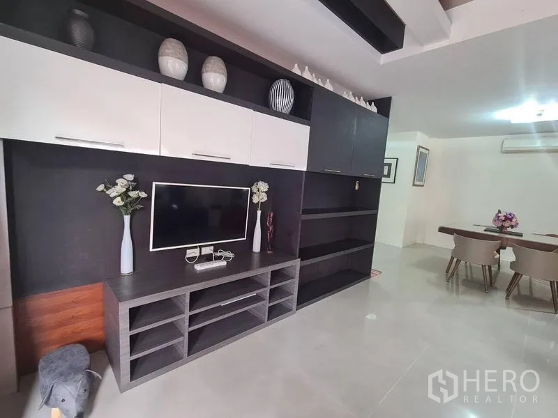Detached House for rent in Sai Mai, Bangkok - Built-in TV wall with cabinets and shelves adjoining the dining area.
