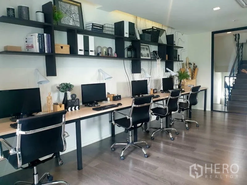 Home Office for rent in Bang Phli, Samut Prakan - Row of workstations with office chairs, desktop monitors and wall shelves.
