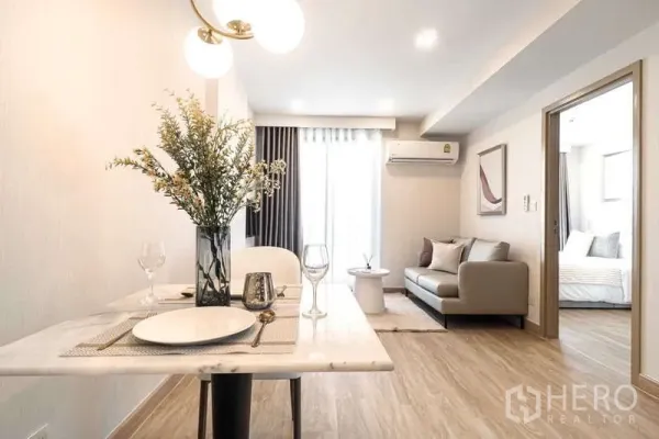 Condominium for rent - Dining to living perspective showing pendant light and sofa by balcony.