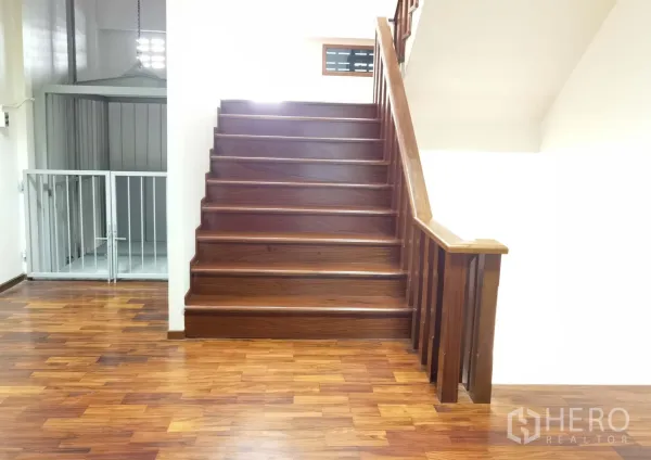 Warehouse for rent in Samut Prakan - Wood staircase beside a freight lift, showing access between warehouse floors.