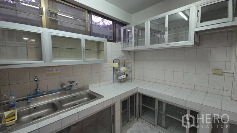 Home Office for rent in Sathon, Bangkok - Close-up of kitchen corner featuring double sink and extensive overhead cabinetry.