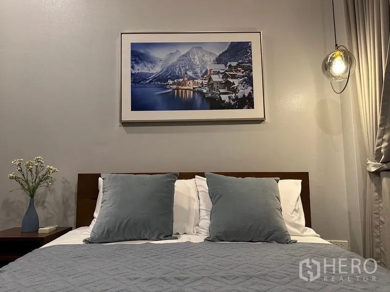 Detached House for rent - Cozy bedroom with double bed, blue pillows and mountain landscape artwork.