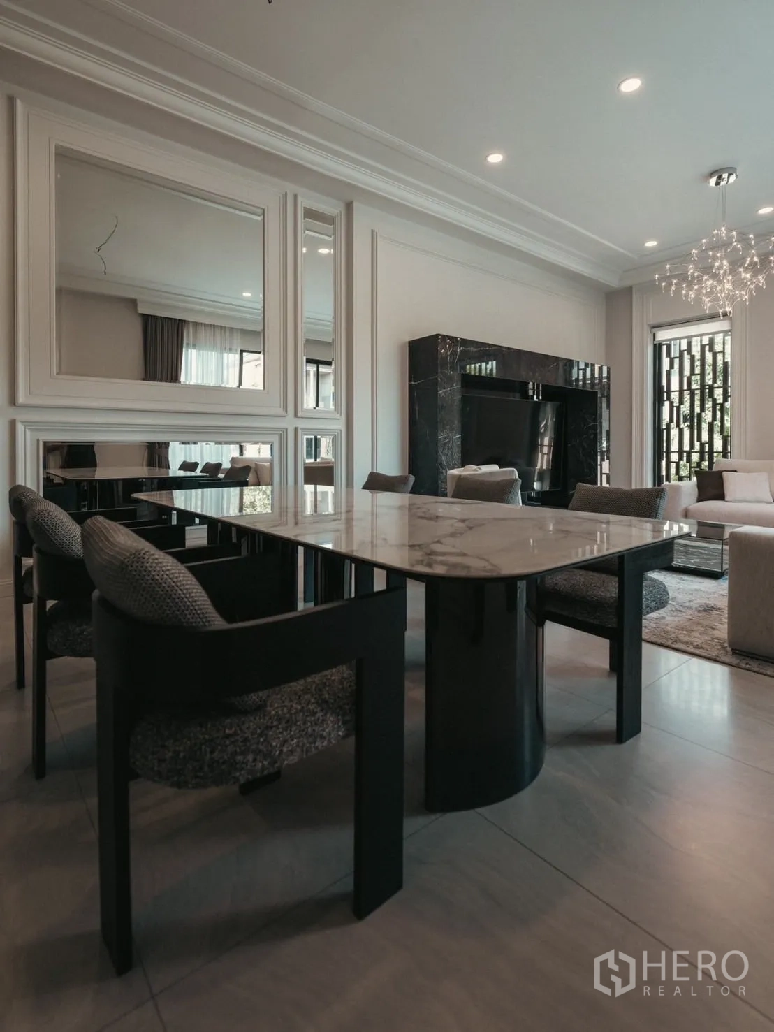 Detached House for rent or sale in Bang Kapi, Bangkok - Side view of marble dining table facing the lounge and black marble TV wall.