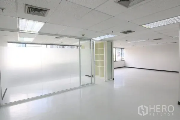 Office Space for rent in Bang Rak, Bangkok - Office area featuring a glass-partitioned meeting room and built-in shelving.
