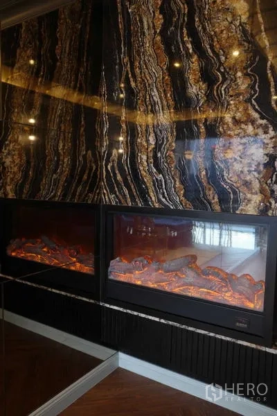 Condominium for sale - Marble feature wall with dual electric fireplaces in an upscale condominium living area.