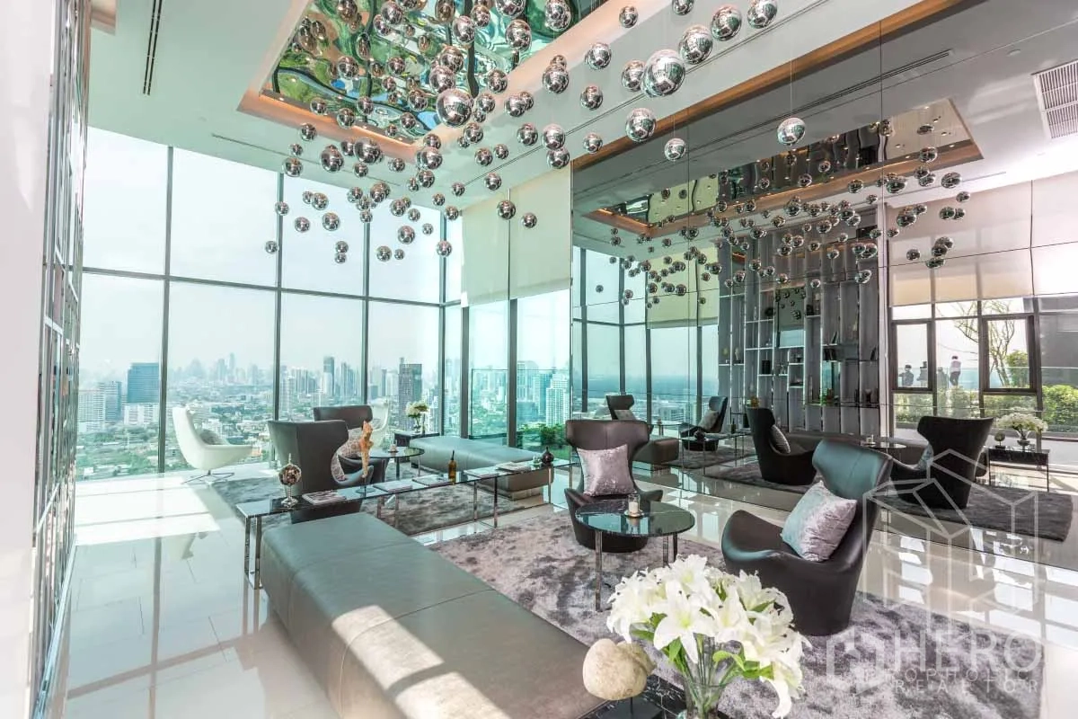 Condominium for rent in Khlong Toei, Bangkok - Luxury condominium sky lounge with panoramic city views and stylish seating.