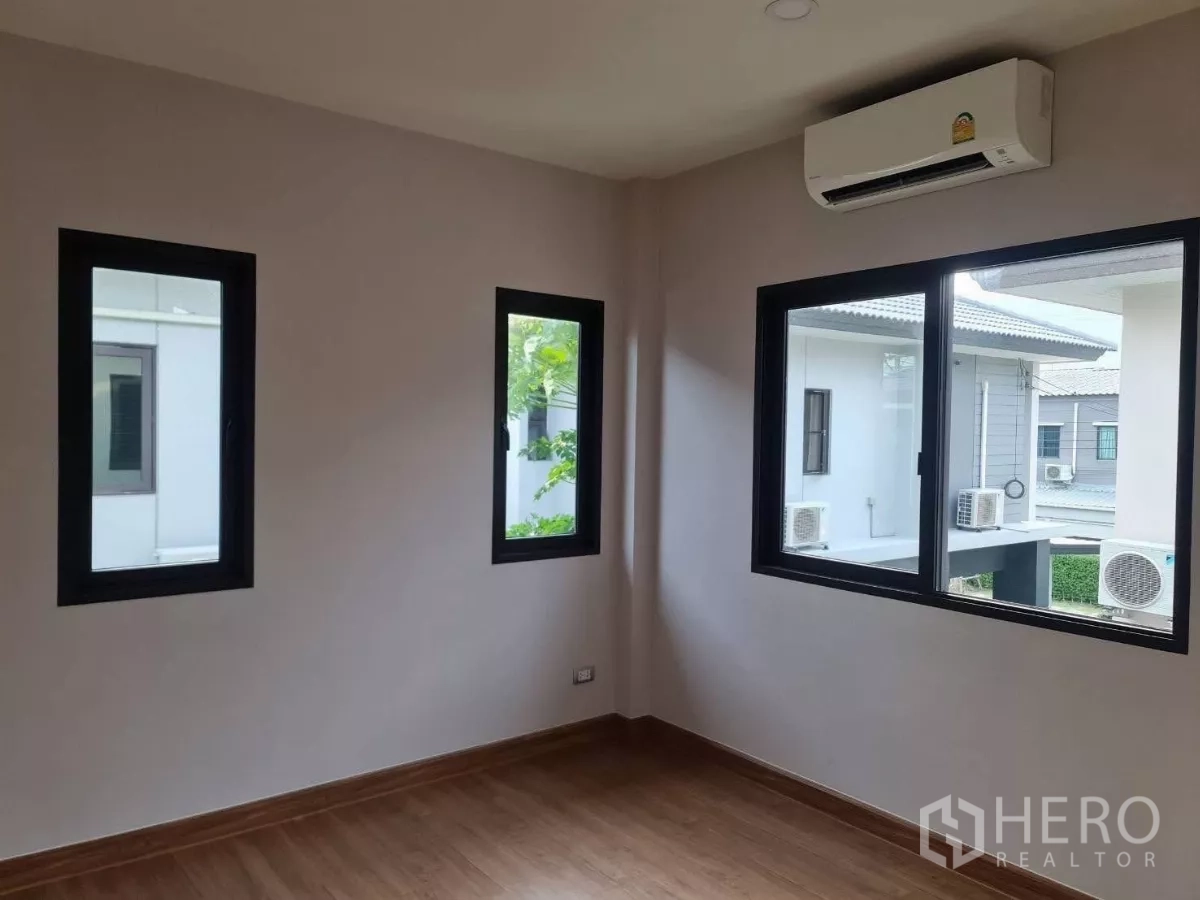 独立式住宅 出售在Samut Prakan - 角落卧室，木地板，三扇窗与壁挂机空调。