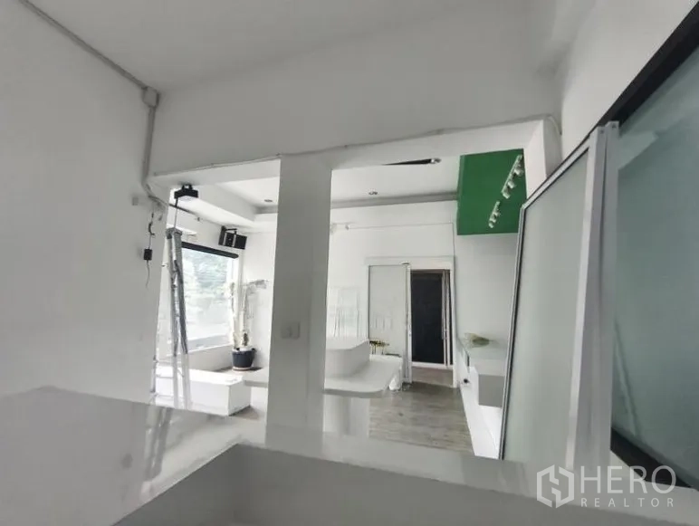 Retail Space for rent in Watthana, Bangkok - Back room and partitioned area within the retail unit, white walls and large windows suitable for storage or prep.