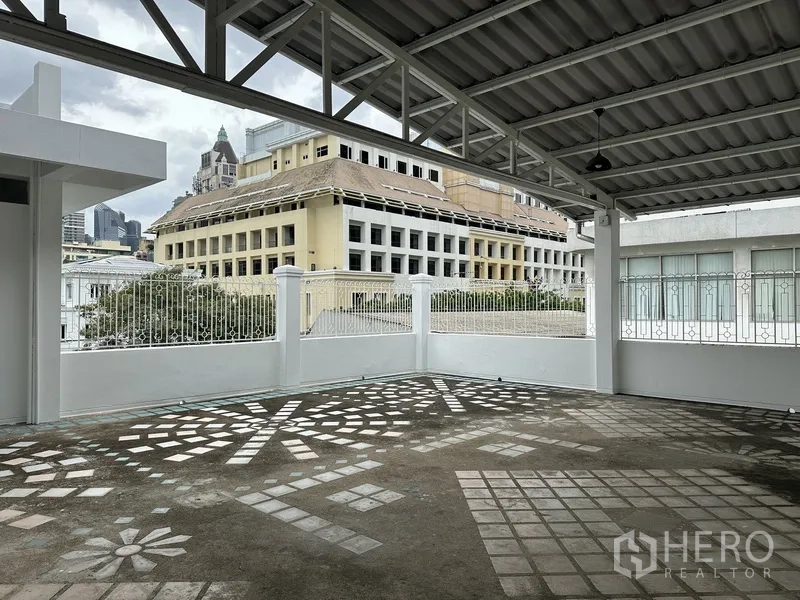 Retail Space for rent in Bang Rak, Bangkok - Covered terrace corner with decorative floor pattern and nearby buildings.