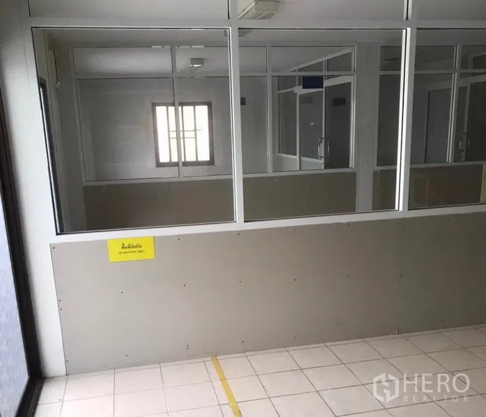 Factory for rent in Bang Bua Thong, Nonthaburi - Corridor with interior windows and partitions for multiple office rooms.