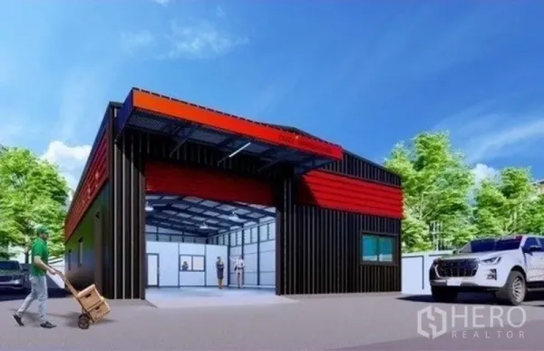 Warehouse for rent in Lat Phrao, Bangkok - Modern black-and-red warehouse exterior with wide roller shutter, driveway and parking in Lat Phrao, Bangkok.
