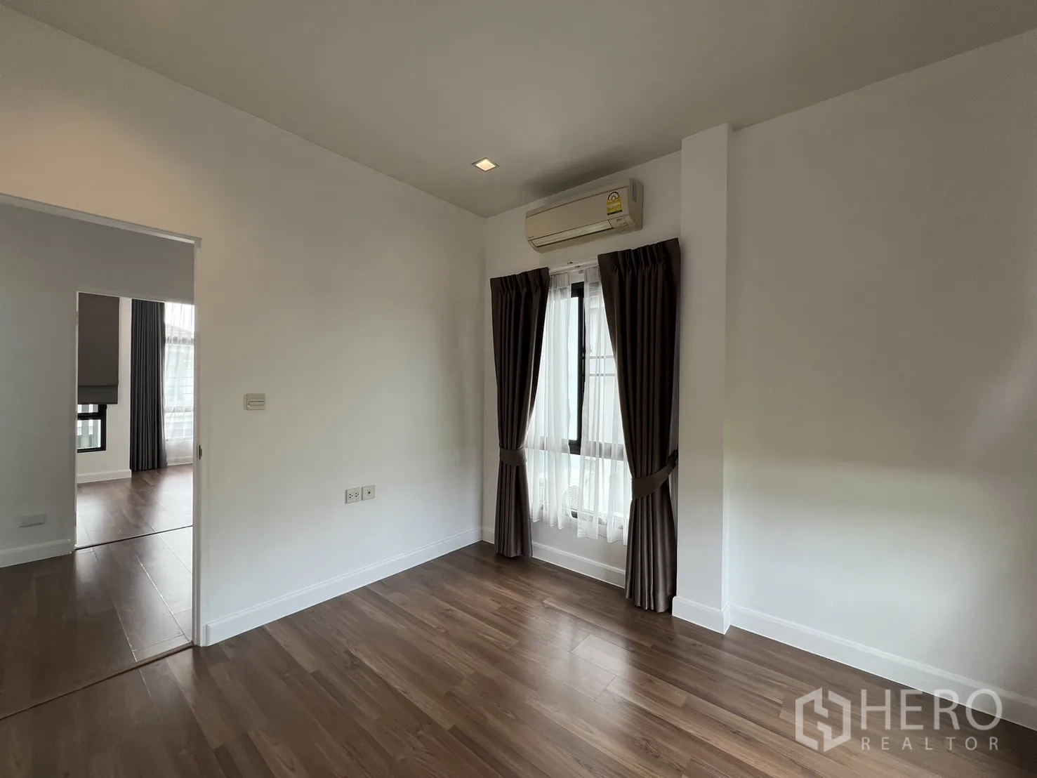 Detached House for rent in Bang Kapi, Bangkok - Third bedroom alternate view with white walls and grey curtains.